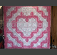 This Log Cabin quilt was pieced by Linda Monasky and machine quilted with diagonal rows of traditional feathers.Top & backing are constructed of quality 100% cotton, batting is low loft polyester. Price includes 2 matching pillow  cases. Machine pieced and quilted by Linda Monasky 